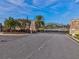 Gated community entrance with stone pillars, landscaping, and a security camera at 11248 Juglans Dr, Odessa, FL 33556
