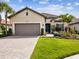 Charming home boasts a tile roof, well-manicured lawn, and lush landscaping at 11248 Juglans Dr, Odessa, FL 33556