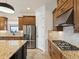Modern kitchen with granite countertops, stainless steel appliances, and a view of the backyard at 11248 Juglans Dr, Odessa, FL 33556