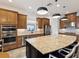 Spacious kitchen with custom cabinetry, a large island, granite countertops, and stainless steel appliances at 11248 Juglans Dr, Odessa, FL 33556