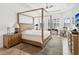 Tranquil main bedroom with a four-poster bed, plantation shutters, and neutral decor at 11248 Juglans Dr, Odessa, FL 33556