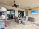 Covered patio with ceiling fans, an outdoor kitchen, and a stunning lake view at 11248 Juglans Dr, Odessa, FL 33556