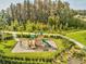 Community playground surrounded by mature landscaping with lush green grass and sidewalks at 11248 Juglans Dr, Odessa, FL 33556