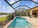 Screened in pool with spa and view of the lake in the backyard of this home at 11248 Juglans Dr, Odessa, FL 33556