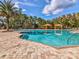 Resort-style pool with lush tropical landscaping and shaded cabanas for relaxing and enjoying the Florida sunshine at 11248 Juglans Dr, Odessa, FL 33556