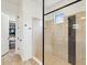 Contemporary bathroom featuring a tiled shower with frameless glass doors and a walk in closet at 11248 Juglans Dr, Odessa, FL 33556