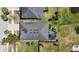 Aerial view highlighting the property's roof, screened lanai, and well-maintained backyard with mature landscaping at 11327 Emerald Shore Dr, Riverview, FL 33579