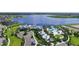 Aerial view of the community amenities featuring a pool, clubhouse, lake, and lush landscaping at 11327 Emerald Shore Dr, Riverview, FL 33579