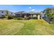 Spacious backyard with a screened-in patio, lush landscaping and fence at 11327 Emerald Shore Dr, Riverview, FL 33579