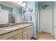 Stylish bathroom with double sinks, granite countertop, and a walk-in shower, offering a modern and functional space at 11327 Emerald Shore Dr, Riverview, FL 33579