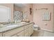 Well-lit bathroom with a granite countertop, white cabinets, and neutral decor, offering a clean and relaxing space at 11327 Emerald Shore Dr, Riverview, FL 33579