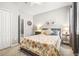 Cozy bedroom with a comfortable floral patterned bed, soft lighting, and ample closet space at 11327 Emerald Shore Dr, Riverview, FL 33579