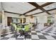 Bright clubhouse with a coffered ceiling, black and white floors, and comfortable seating areas at 11327 Emerald Shore Dr, Riverview, FL 33579