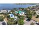 Stunning community pool area with mature palms, sunshades, and splash pad, surrounded by beautiful landscaping at 11327 Emerald Shore Dr, Riverview, FL 33579