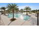 Resort-style community pool with palm trees, lounge chairs, cabanas, and ample space for relaxation and recreation at 11327 Emerald Shore Dr, Riverview, FL 33579