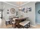 Charming dining area with a decorative chandelier, modern decor, and adjacent wine bar at 11327 Emerald Shore Dr, Riverview, FL 33579