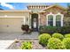 Beautiful home with stone accents, manicured landscaping, and a two-car garage at 11327 Emerald Shore Dr, Riverview, FL 33579