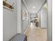 Bright hallway with neutral paint, recessed lighting, tile floors, and decorative artwork at 11327 Emerald Shore Dr, Riverview, FL 33579
