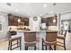 Open kitchen featuring granite countertops, dark wood cabinets, and stainless steel appliances at 11327 Emerald Shore Dr, Riverview, FL 33579