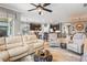 Bright living area with comfortable seating, ceiling fan, and view into the kitchen, creating a warm and inviting atmosphere at 11327 Emerald Shore Dr, Riverview, FL 33579