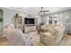 Inviting living room with comfortable seating, a ceiling fan, and plenty of natural light at 11327 Emerald Shore Dr, Riverview, FL 33579