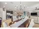 Open-concept floor plan featuring chandelier, dining area, and inviting living space with neutral tones and recessed lighting at 11327 Emerald Shore Dr, Riverview, FL 33579
