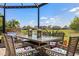 Screened-in patio features outdoor dining set with a picturesque view at 11327 Emerald Shore Dr, Riverview, FL 33579