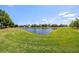 Scenic view of the pond from the backyard showcases the beautiful landscaping at 11327 Emerald Shore Dr, Riverview, FL 33579