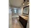 Bathroom featuring a dark wood vanity with granite countertop and a tile floor at 1200 Abbey Crescent Ln, Clearwater, FL 33759