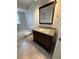Bathroom featuring a dark wood vanity with granite countertop and a tile floor at 1200 Abbey Crescent Ln, Clearwater, FL 33759