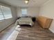 Bright bedroom featuring wood floors, two windows, and ample closet space for organized living at 1200 Abbey Crescent Ln, Clearwater, FL 33759