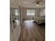 Inviting bedroom with a mirror, wood floors, two windows, and ample closet space at 1200 Abbey Crescent Ln, Clearwater, FL 33759