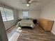 Inviting bedroom with lots of light, featuring wood floors, two windows, and ample closet space at 1200 Abbey Crescent Ln, Clearwater, FL 33759