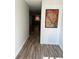 Hallway featuring wood-look floors and an art piece at 1200 Abbey Crescent Ln, Clearwater, FL 33759
