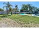 Spacious backyard showcasing a pool, mature trees, and lush lawn, creating a perfect outdoor oasis at 1209 W Camellia Dr, Brandon, FL 33510