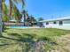 The large backyard features a pool, lanai, mature trees, and a well-maintained lawn at 1209 W Camellia Dr, Brandon, FL 33510