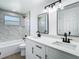 Modern bathroom featuring double sinks, stylish mirrors, and tiled shower with tub at 1209 W Camellia Dr, Brandon, FL 33510