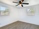 Bedroom with wood-look floors, white walls, a ceiling fan and dual windows at 1209 W Camellia Dr, Brandon, FL 33510