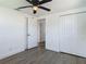 Bedroom with wood-look flooring, white walls, and a double closet at 1209 W Camellia Dr, Brandon, FL 33510