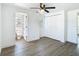 Bright bedroom featuring wood-look floors, ceiling fan, closet, and ensuite bathroom with shower and toilet at 1209 W Camellia Dr, Brandon, FL 33510
