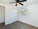 Bright bedroom with wood-look floors, ceiling fan, closet, and a window at 1209 W Camellia Dr, Brandon, FL 33510