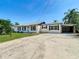 Charming home featuring a well-manicured lawn and a convenient covered carport, enhancing curb appeal at 1209 W Camellia Dr, Brandon, FL 33510