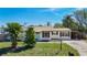 Charming single-story home with a well-manicured lawn, mature trees, and inviting curb appeal at 1209 W Camellia Dr, Brandon, FL 33510
