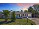 Charming single-story home with a well-manicured lawn, mature trees, and inviting curb appeal at 1209 W Camellia Dr, Brandon, FL 33510