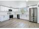 Updated kitchen featuring stainless steel appliances, granite countertops, and modern white cabinetry at 1209 W Camellia Dr, Brandon, FL 33510