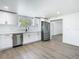 Well-lit kitchen with stainless steel appliances, light countertops and new fixtures at 1209 W Camellia Dr, Brandon, FL 33510