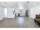 Bright and open-concept living space with modern wood flooring and white walls at 1209 W Camellia Dr, Brandon, FL 33510