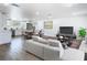 Bright open-concept living space featuring modern decor and updated kitchen with stainless steel appliances at 1209 W Camellia Dr, Brandon, FL 33510