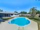 The freeform pool, set in a grassy yard, provides an inviting spot for relaxation and outdoor enjoyment at 1209 W Camellia Dr, Brandon, FL 33510