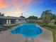 Backyard featuring a refreshing blue in-ground pool with a spacious patio and lush greenery at 1209 W Camellia Dr, Brandon, FL 33510
